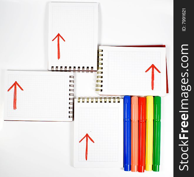 Four open notebooks with arrows and colors felt-tip pens. Four open notebooks with arrows and colors felt-tip pens