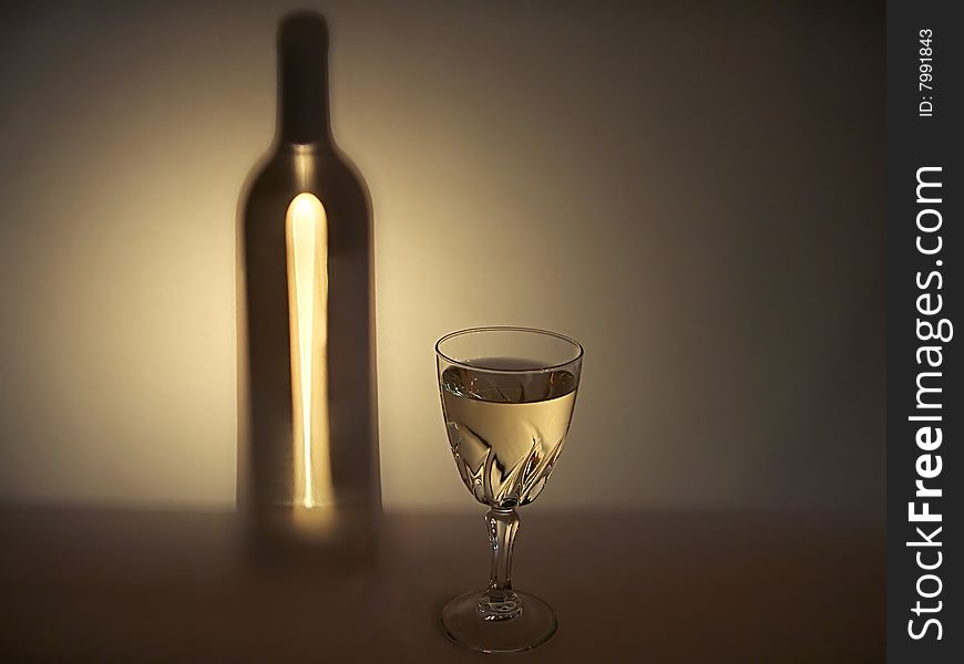 Wineglass of white wine and silhouette of a bottle with wine. Wineglass of white wine and silhouette of a bottle with wine.