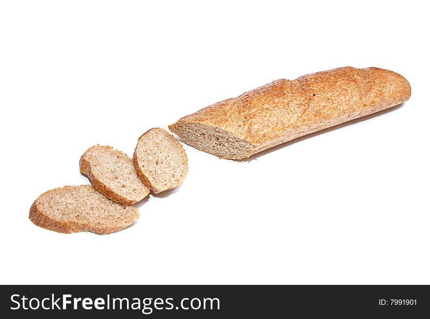 Half of the long loaf and three pieces isolated on a white background. Half of the long loaf and three pieces isolated on a white background.