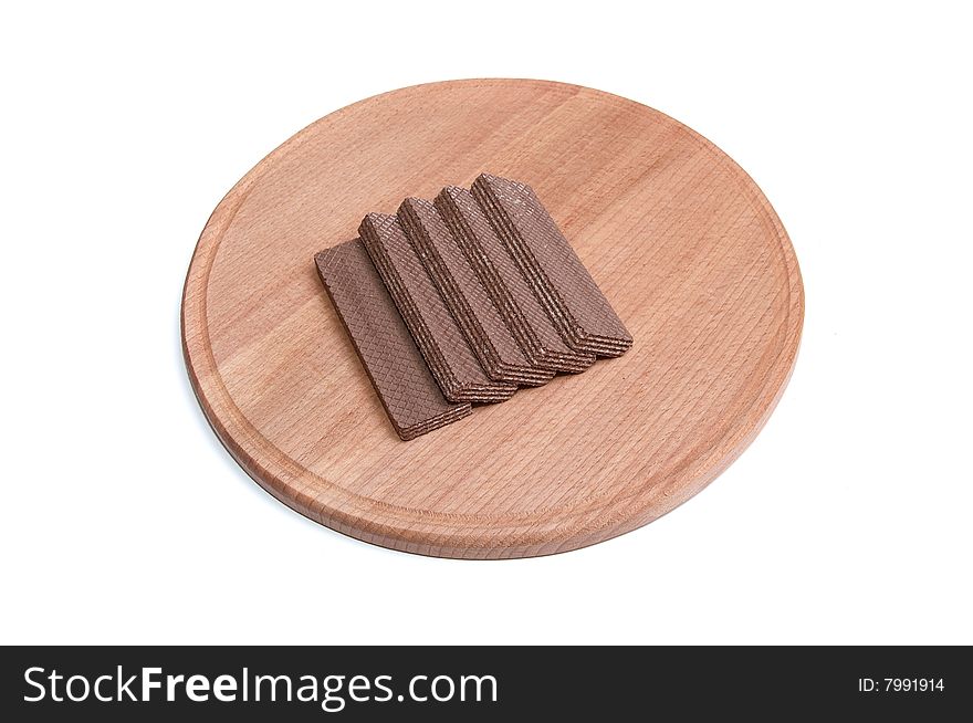 Brown wafers at the round desk isolated on a white background. Brown wafers at the round desk isolated on a white background.