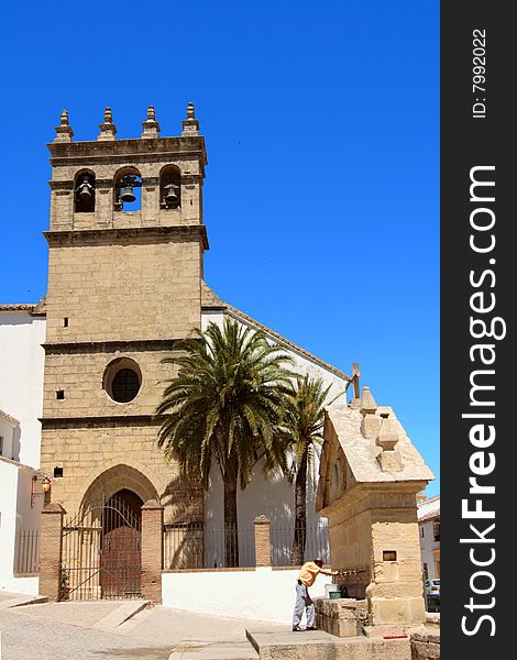 A Spanish church with its fountain in a small picuresque Spanish village