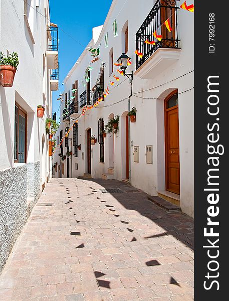 A quiet cobbled street in a small Spanish village. A quiet cobbled street in a small Spanish village.