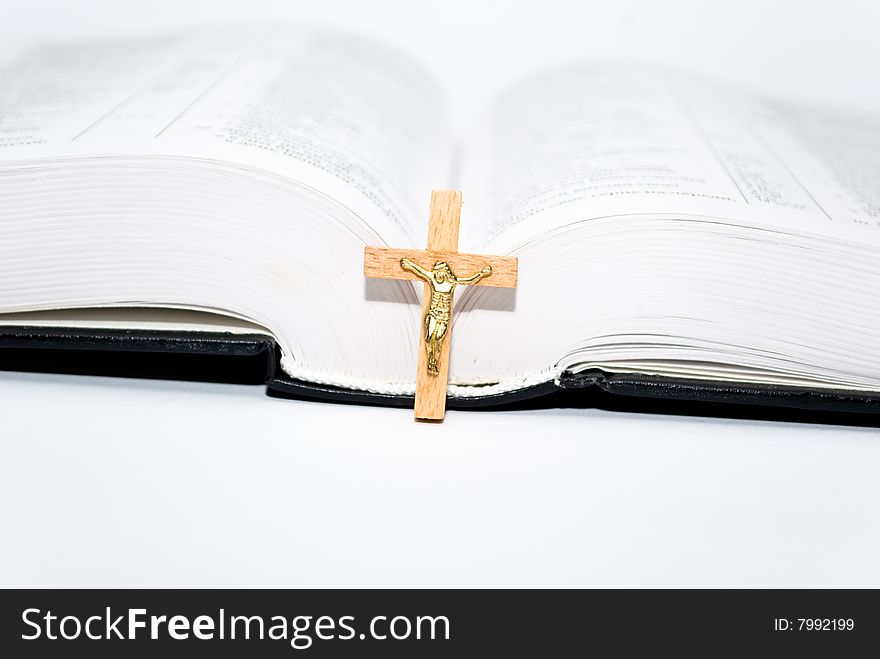 Book and cross on the white background