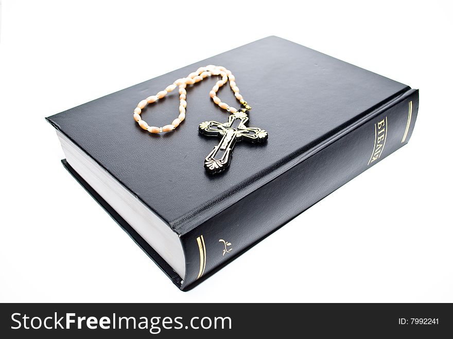 Book and cross on the white background