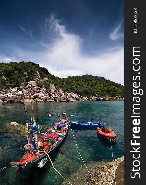 A fishing boat and two smaller boats in a calm bay in Koh Tao, Thailand. A fishing boat and two smaller boats in a calm bay in Koh Tao, Thailand