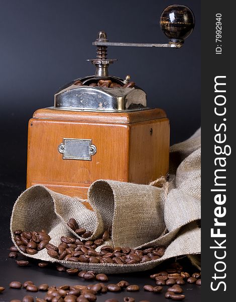 Retro coffee grinder on a black bacground