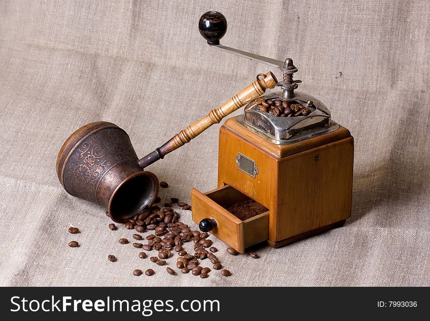 Retro coffee grinder on a grey bacground
