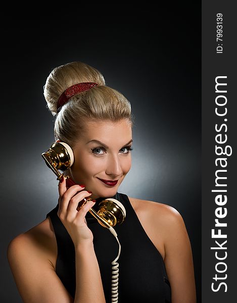 Lovely woman talking on the phone. Retro portrait