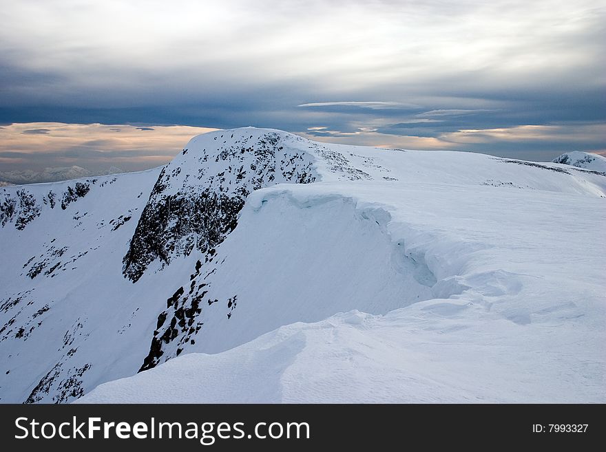 Winter landscape of a snow covered mountain cornice in scotland. Winter landscape of a snow covered mountain cornice in scotland