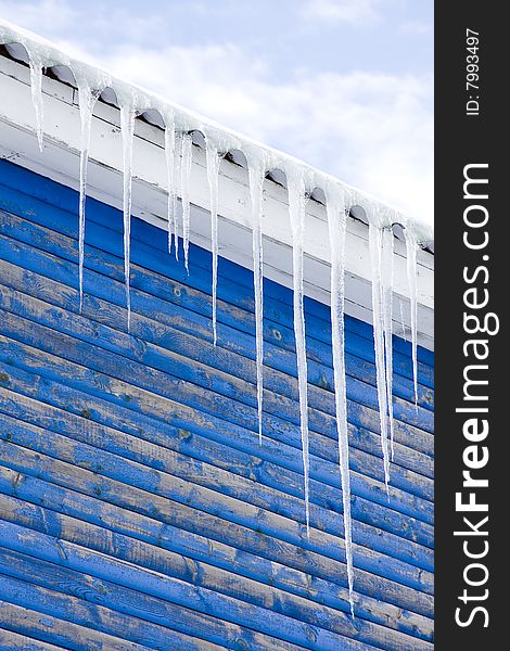 Icicles on a roof, blue 	boards