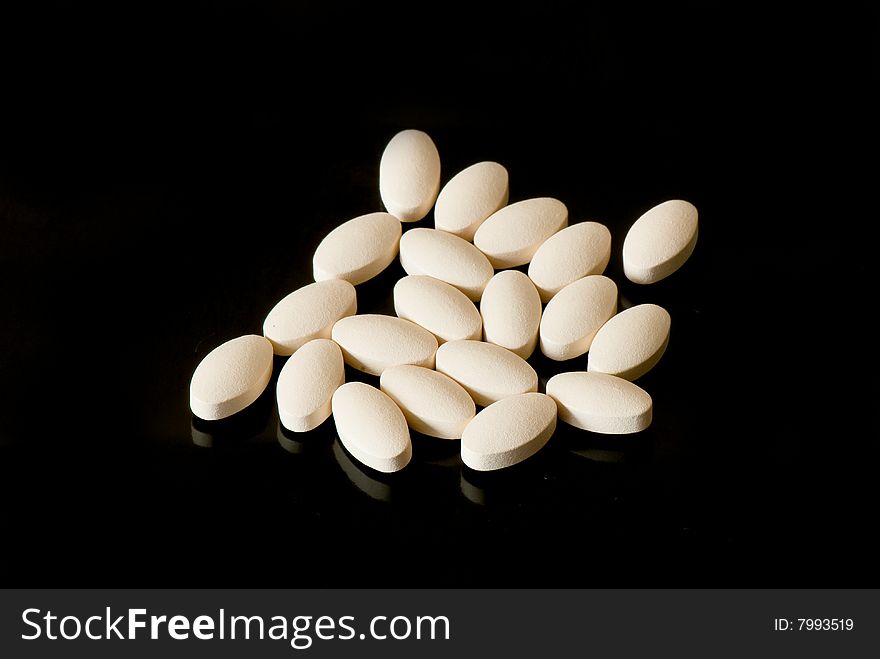 Colored oblong pills on the isolated background
