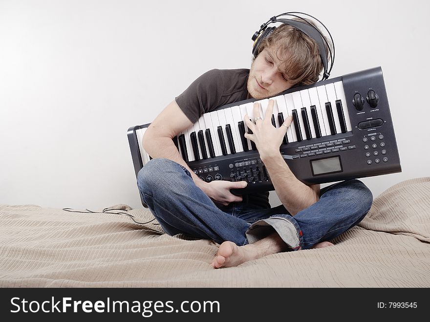Man Hugs A MIDI-keyboard