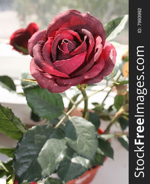 Artificial red rose. Lifeless but beautiful. Artificial red rose. Lifeless but beautiful