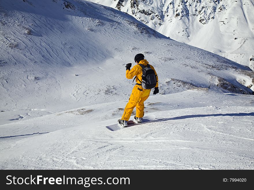 Snowboarder Looking Down The Slope. Sunny DaySnowb