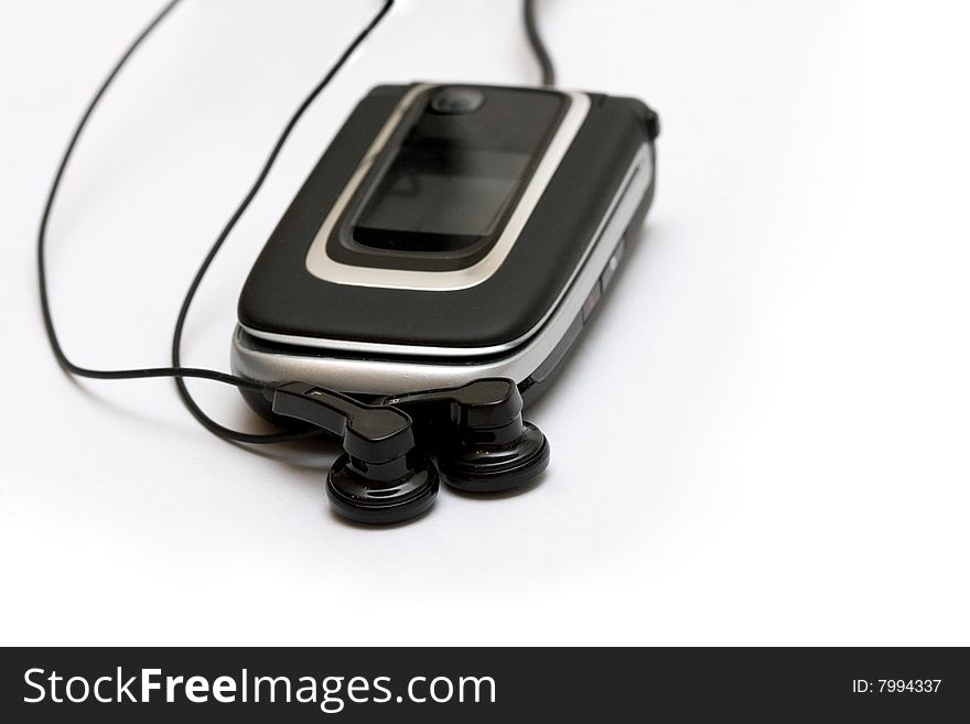 Mobile phone with headphones on white background. Mobile phone with headphones on white background
