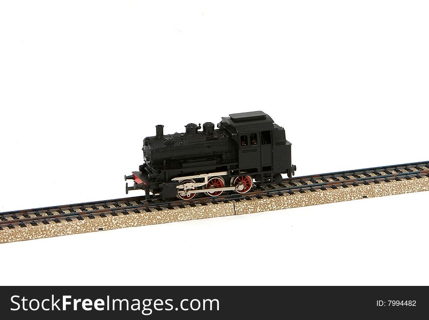 Model train with rails on a white bakcground. Model train with rails on a white bakcground