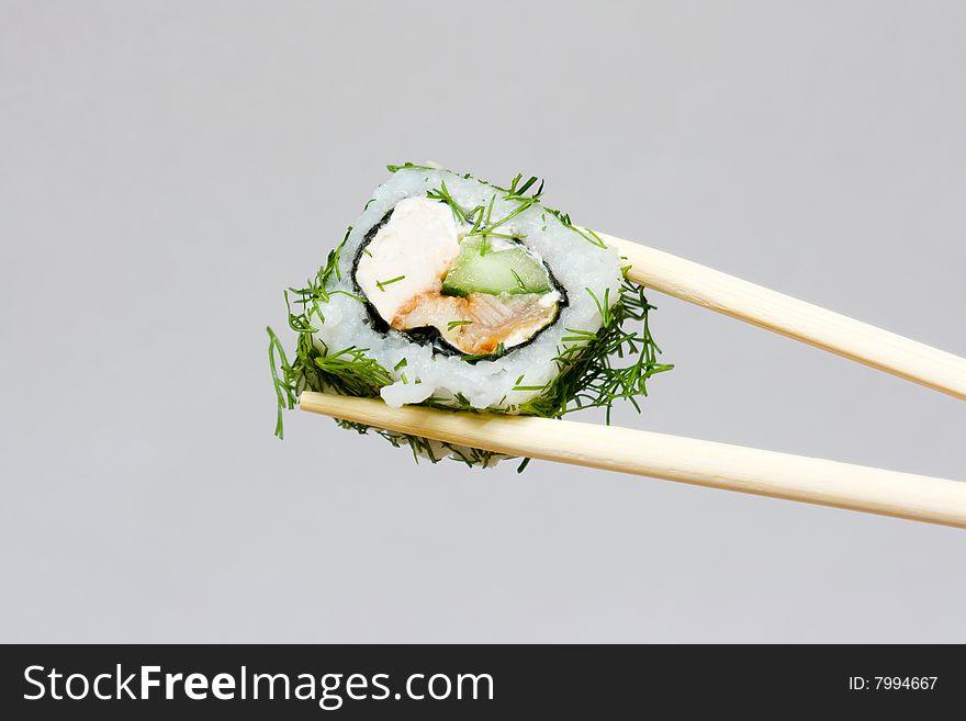 Sushi and chopsticks on the neutral background