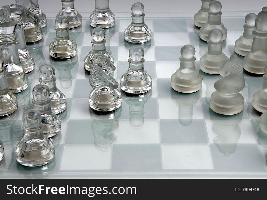 Chess board with pieces in glass