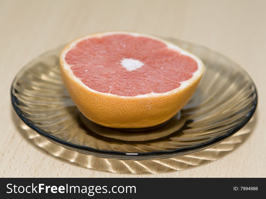 Half of the cut orange on a saucer