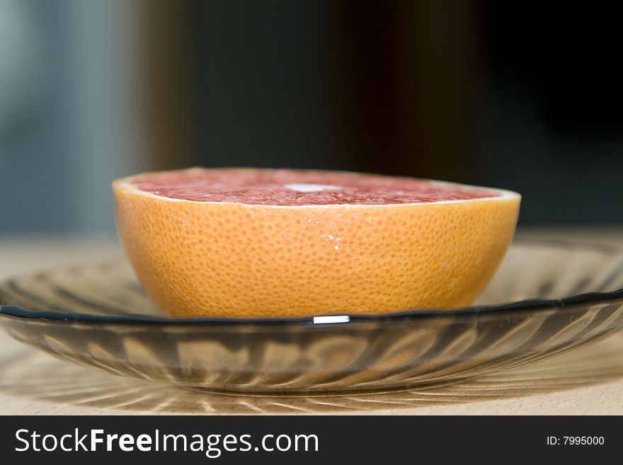 Half of the cut orange on a saucer