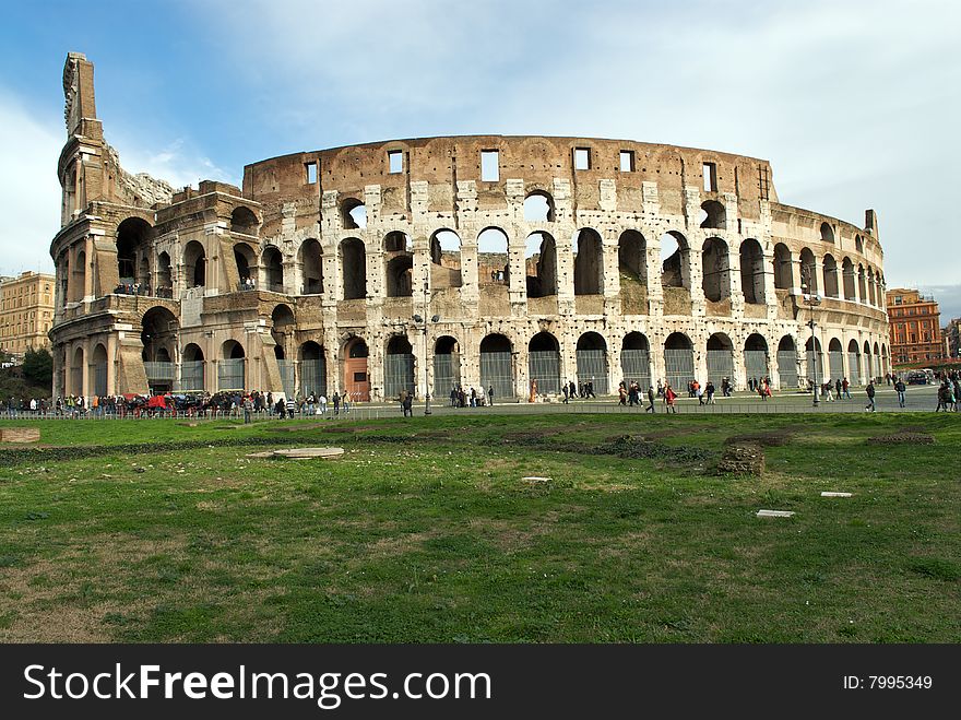 A shot of the famous Colosseum taken in a winter day. You can see also many tourists wich go around the huge monument. A shot of the famous Colosseum taken in a winter day. You can see also many tourists wich go around the huge monument.