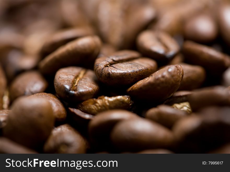 Freshly roasted coffee beans on sackcloth with copyspace. Shallow depth of field. Focus on center of image