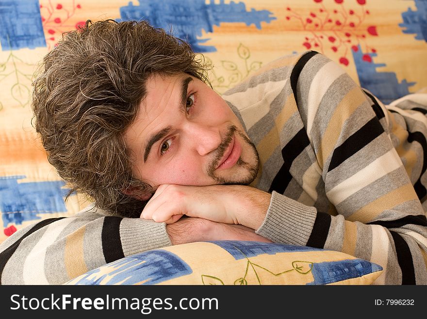 Young Handsome Male On Colourful Sofa