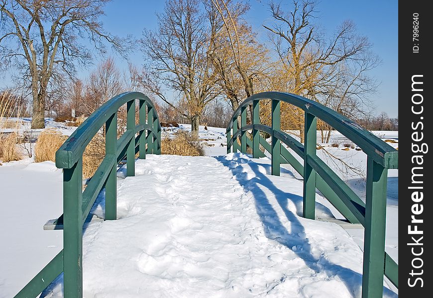 A snow covered bridge in a winter landscape