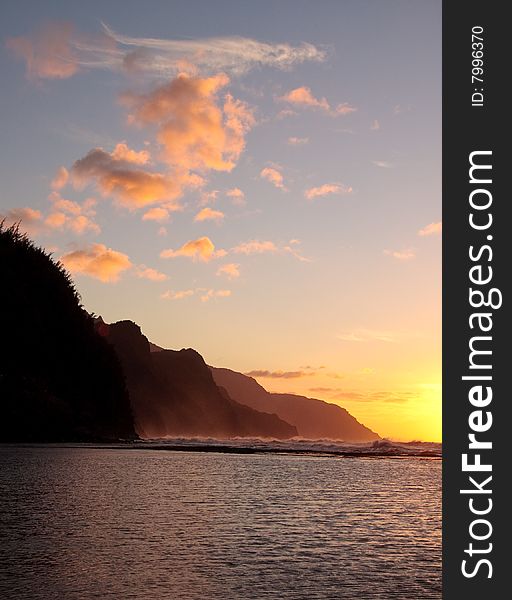 Vertical format of the headlands of the Kauai coast illuminated at sunset. Vertical format of the headlands of the Kauai coast illuminated at sunset