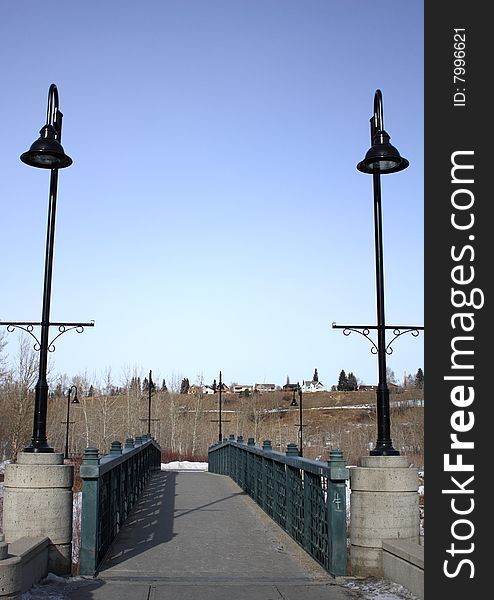 Front view of a bridge with two road lamps