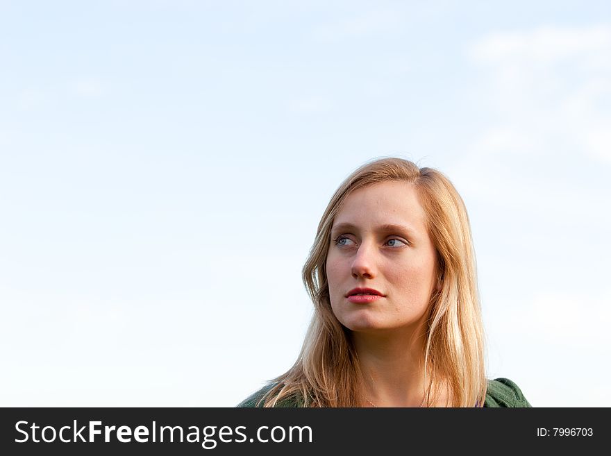 A female model looks up and away while being photographed in a way where there is extra room for text or copy space. A female model looks up and away while being photographed in a way where there is extra room for text or copy space.