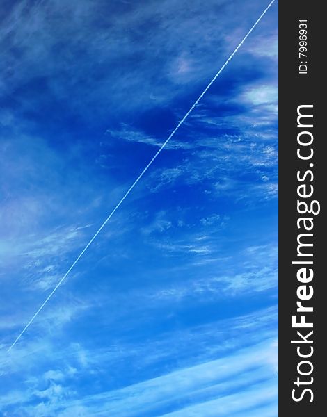 Beautiful clouds and sky with flying airplane jet on background