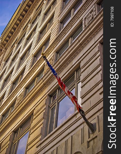 This is an American Flag wrapped around a pole on a building. This is an American Flag wrapped around a pole on a building