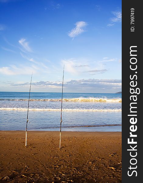 Surfcasting rods in the sand at Taipa Beach on a beautiful Summer evening, Northland, New Zealand. Surfcasting rods in the sand at Taipa Beach on a beautiful Summer evening, Northland, New Zealand