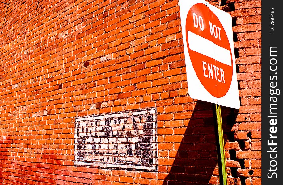 Brick wall and Do Not Enter sign with striking orange colors. Brick wall and Do Not Enter sign with striking orange colors