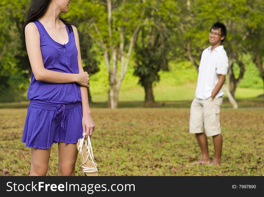 A loving couple enjoying intimate moments in the outdoor. A loving couple enjoying intimate moments in the outdoor