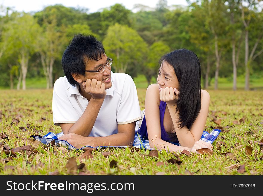 A loving couple enjoying intimate moments in the outdoor. A loving couple enjoying intimate moments in the outdoor