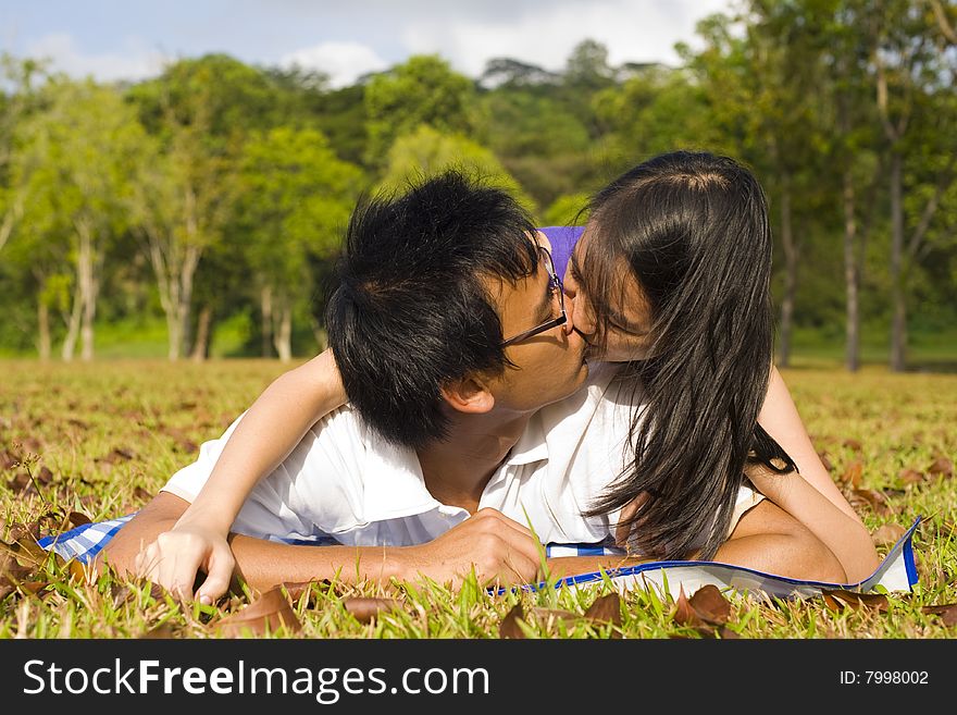 A loving couple enjoying intimate moments in the outdoor. A loving couple enjoying intimate moments in the outdoor