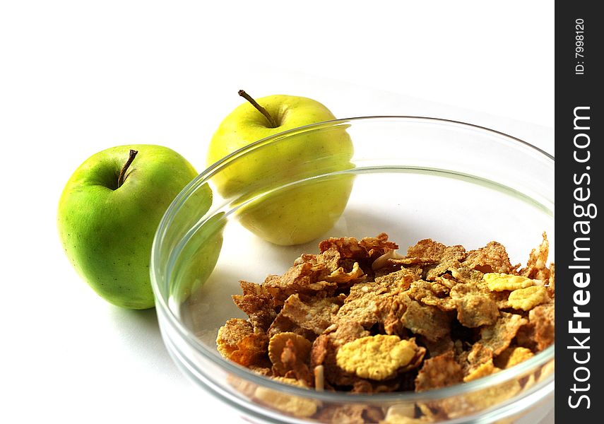 Delicious muesli in a glanse dish with two apple isolated