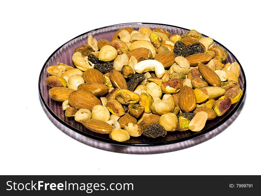 Plate with roasted nuts isolated on white. Plate with roasted nuts isolated on white