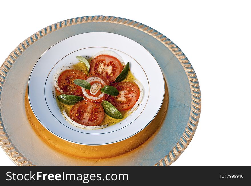 A dish of fresh tomato's and onion with Sage leaves served in Olive Oil. A dish of fresh tomato's and onion with Sage leaves served in Olive Oil.