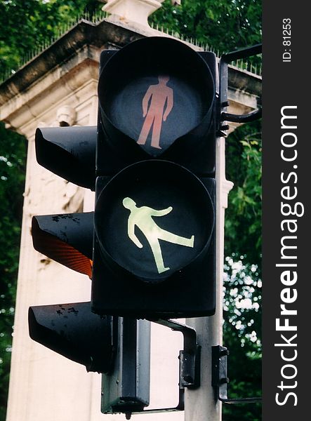 Traffic Light with a crooked lighted green man. Looks like he is walking up inside the traffic light. Traffic Light with a crooked lighted green man. Looks like he is walking up inside the traffic light