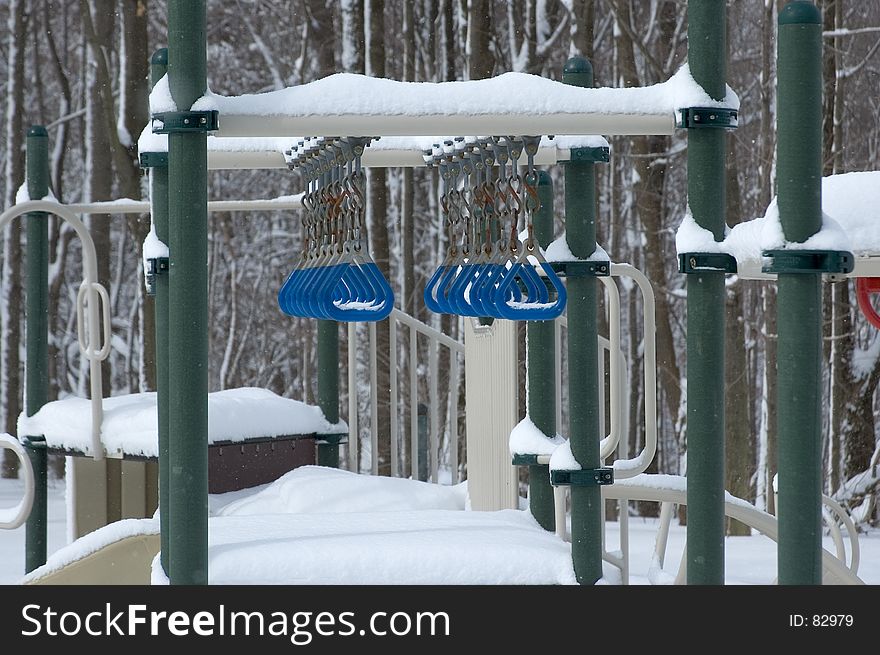 2 rows of blue rings stand out on the snowy, colorless children's playground