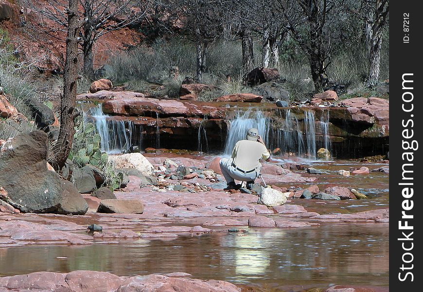 Waterfalls, with photographer in the foreground, with just slow enough shutter to get flow in the water. Waterfalls, with photographer in the foreground, with just slow enough shutter to get flow in the water.