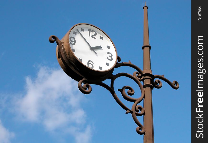 A classical clock over the blue sky. A classical clock over the blue sky