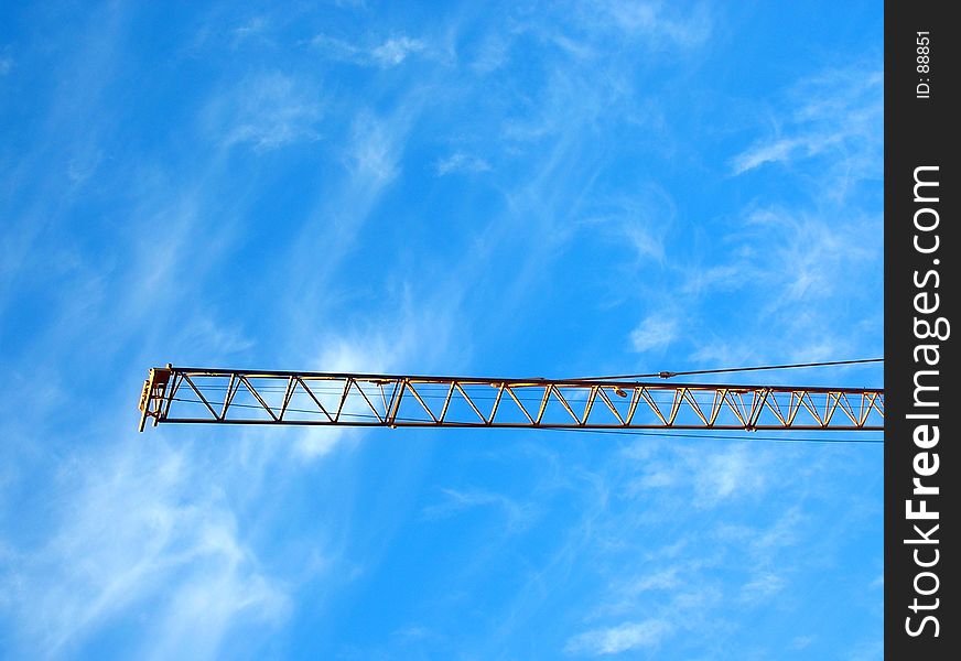 Typical industrial setting: crane's gibbet (jib) on blue sky. Typical industrial setting: crane's gibbet (jib) on blue sky