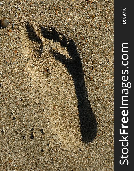 A footprint in the sand. A footprint in the sand.
