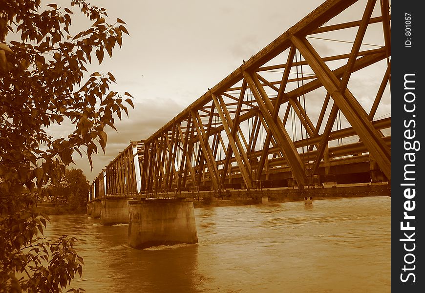 Looking at a rare walking bridge from the river bank. (auto. noise reduction in camera). Looking at a rare walking bridge from the river bank. (auto. noise reduction in camera).