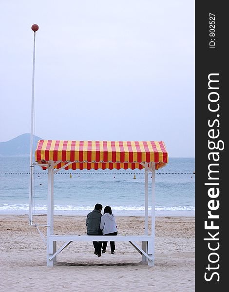 Love birds huddle at the sea. Love birds huddle at the sea