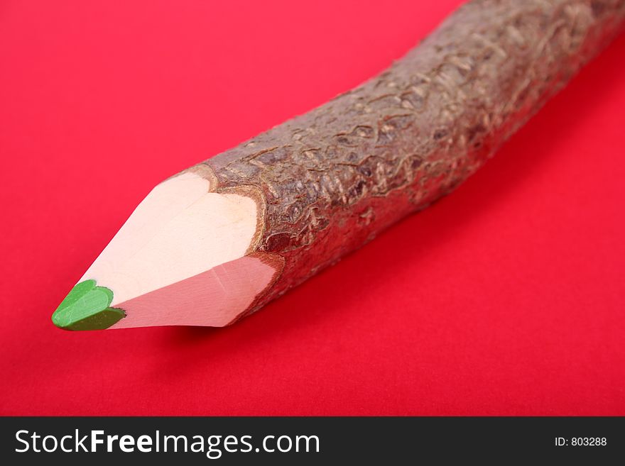 Color wooden pencil over red